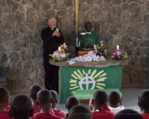 Pastor Dave administers Communion during Sunday worship at Maasae Girls Lutheran Secondary School in Arusha, Tanzania.